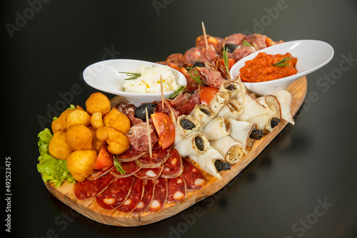 Antipasti served on a wooden board photo