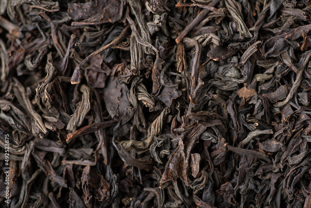 Close-up view of dried leaves of black tea. Black tea background Close-up view of dried leaves of black tea. Black tea background