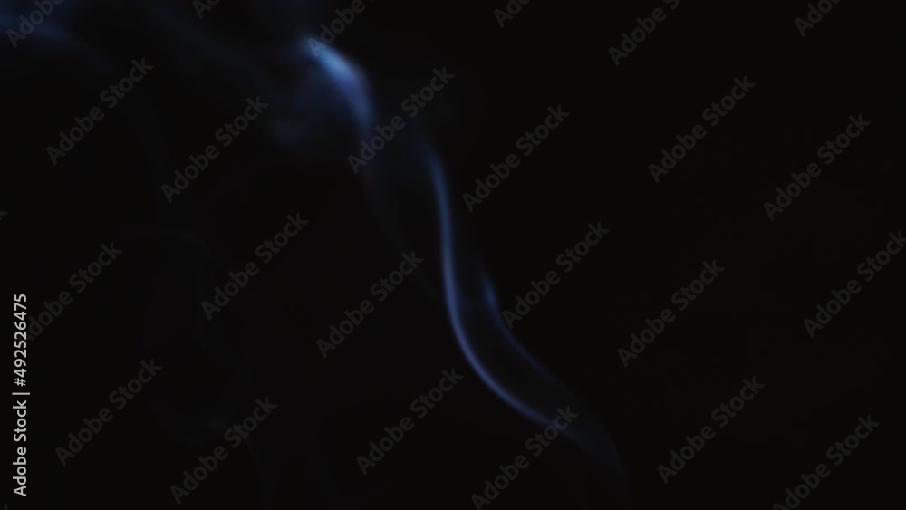 Abstract blue color smoke with a black background in slow motion. Realistic cloud smoke with streamline pattern. Abstract blue color smoke with a black background in slow motion. Realistic cloud smoke with streamline pattern.