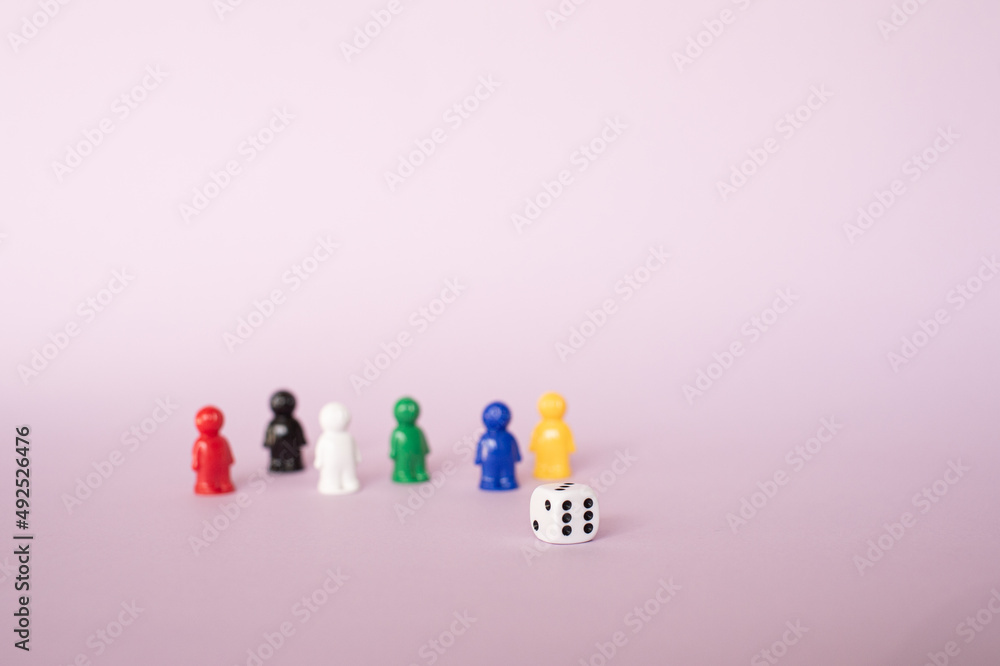 Small colored figures with a cube for a board game