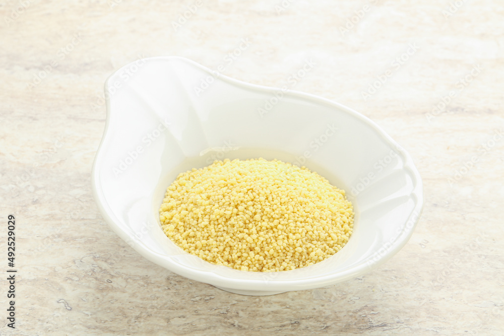 Raw couscous in the bowl Raw couscous in the bowl