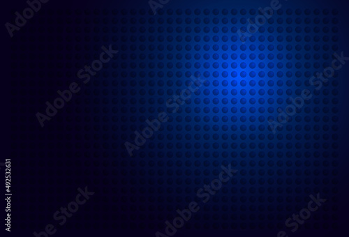 abstract background,simple background with black dot pattern on a blue glowing background © Natwaree