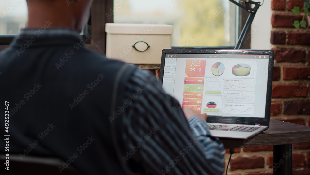 Sales assistant planning business charts on digital laptop, working ...