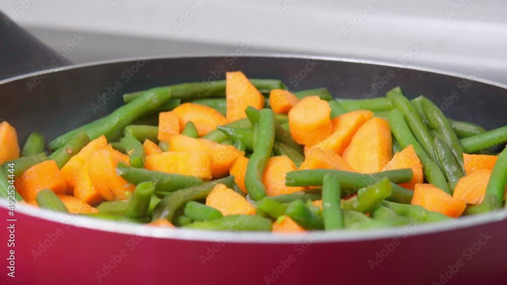 Cooking green beans with carrots close-up, selective focus. Veggie food Cooking green beans with carrots close-up, selective focus. Veggie food