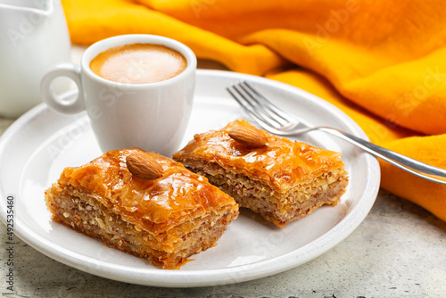 Middle Eastern and Mediterranean Baklava and espresso coffee. Layered pastry dessert made of filo pastry, filled with chopped almond nuts, and sweetened with syrup or honey. Homemade.