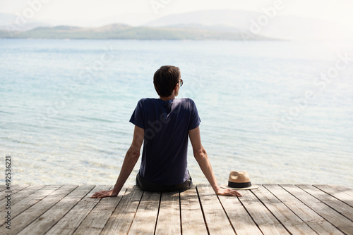 Enjoying life, Back side of young man looking at the sea, travel, vacations lifestyle, mindfulness, summer fun, tourism concept