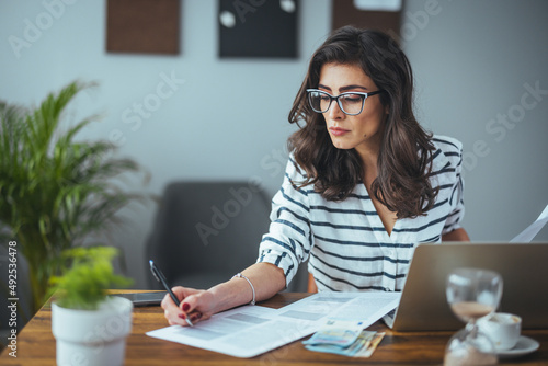 Photography A smart business woman who keeps a paper account using a calculator, an old woma
