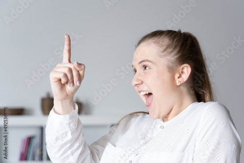 Closeup portrait of young happy woman getting idea