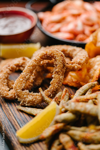 Squid rings, fried sprat, chips, shrimp, Seafood beer appetizers.