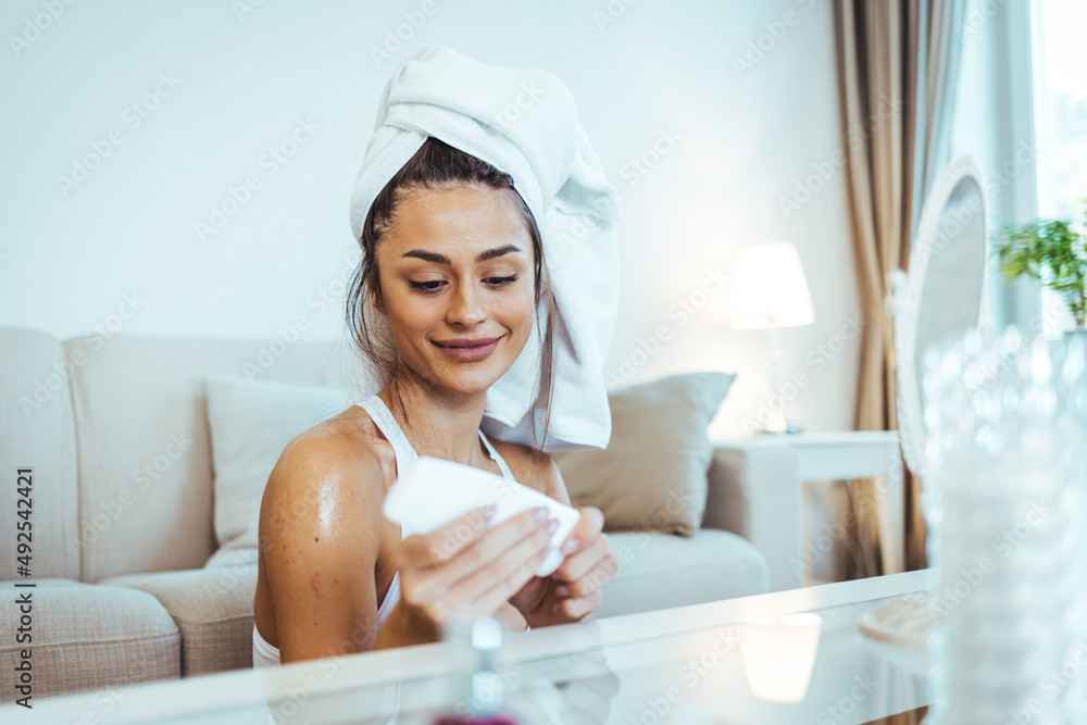 Beauty girl looking at mirror while touching her face and checking pimple, wrinkles and bags under the eyes, during morning beauty routine. Beauty girl looking at mirror while touching her face and checking pimple, wrinkles and bags under the eyes, during morning beauty routine.