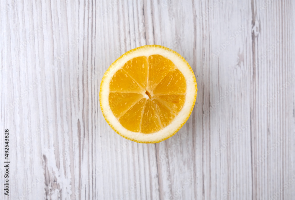 Half a lemon on a wooden table. Citrus. Fruit. Healthy food Half a lemon on a wooden table. Citrus. Fruit. Healthy food