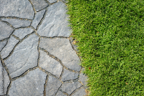 The paving and lawn of a modern garden, seen from above. Garden path.