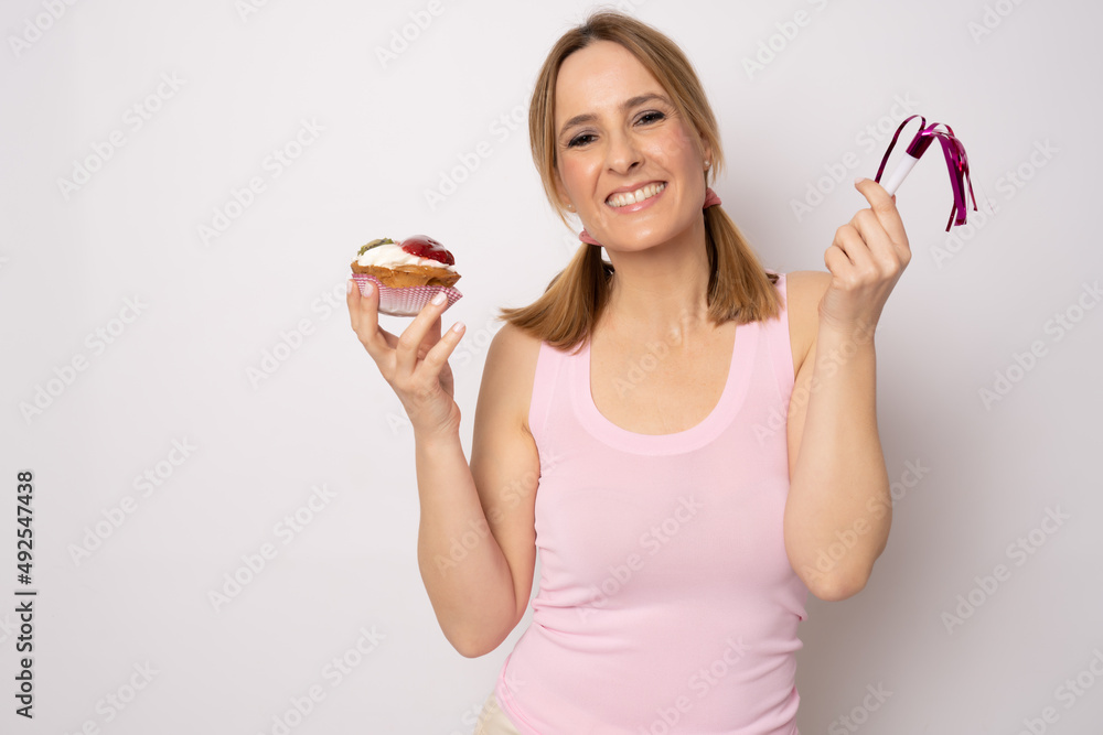 Image of happy woman in casual clothes holding piece of birthday cake isolated over white background. Celebration concept. Image of happy woman in casual clothes holding piece of birthday cake isolated over white background. Celebration concept.