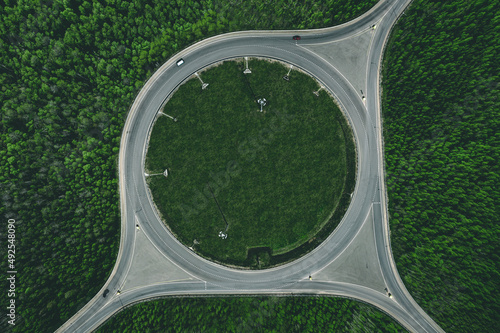 Aerial view of a traffic roundabout and road junctions in green forest photo