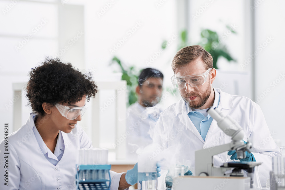 scientists examining control samples in the laboratory . scientists examining control samples in the laboratory .