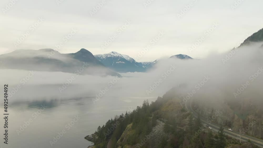 Aerial panoramic view of Sea to Sky Highway near Horseshoe Bay during a sunny winter evening before sunset. Located between Squamish and West Vancouver, British Columbia, Canada. Aerial panoramic view of Sea to Sky Highway near Horseshoe Bay during a sunny winter evening before sunset. Located between Squamish and West Vancouver, British Columbia, Canada.