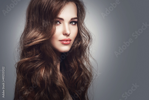 Beautiful young woman with long wavy hair