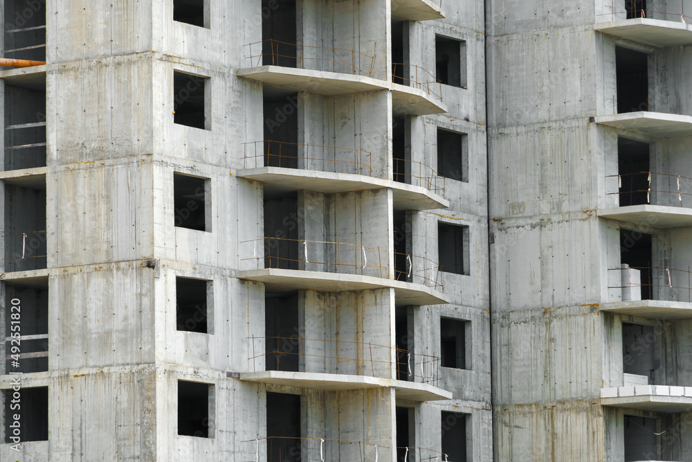 construction of a modern high-rise building, the creation of a concrete frame, building materials and a construction crane construction of a modern high-rise building, the creation of a concrete frame, building materials and a construction crane