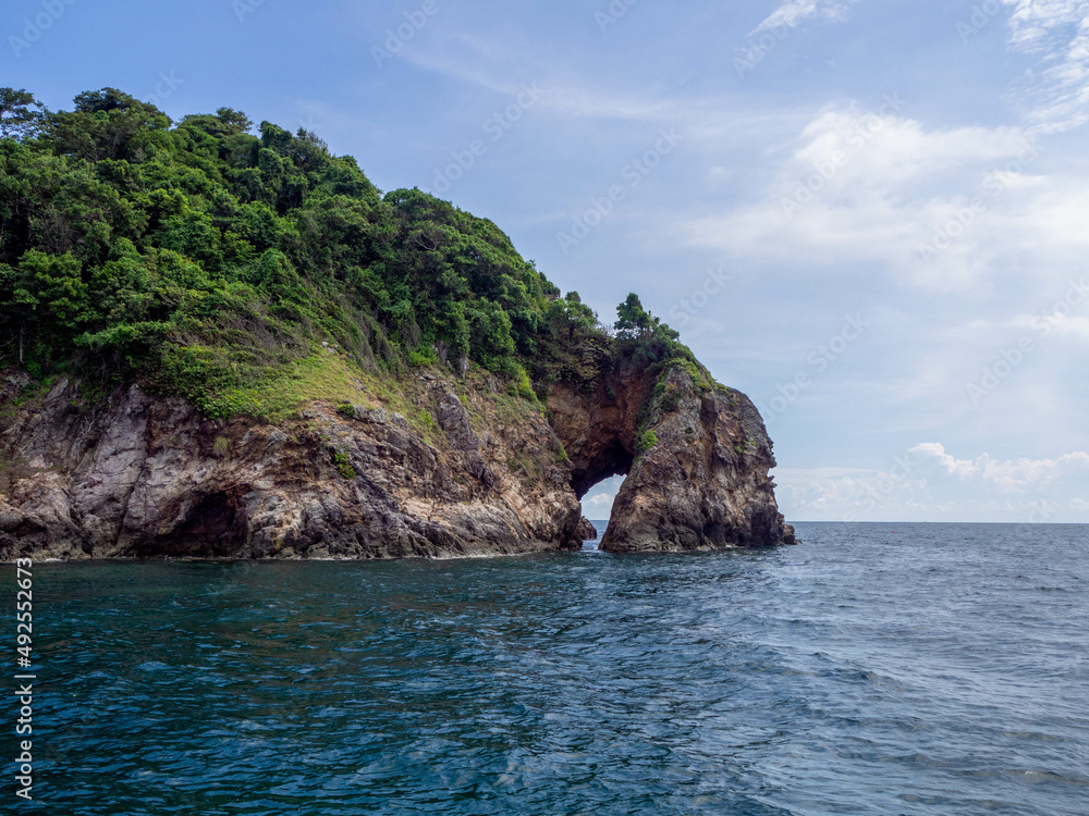 The green island in the beautiful blue sea and clear sky. The green island in the beautiful blue sea and clear sky.