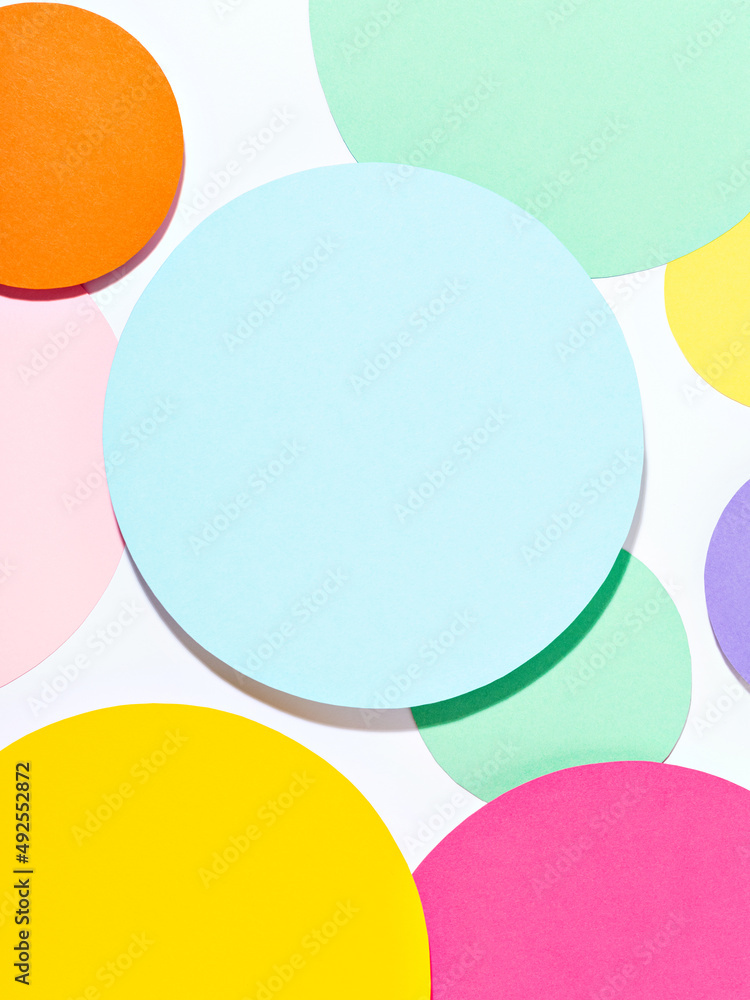 Fun bright coloured mosaic of paper circles in pink, blue, yellow and purple colours. Minimalist background in pastel tones. Creative conceptual template for styling and design. Mock up for text. Fun bright coloured mosaic of paper circles in pink, blue, yellow and purple colours. Minimalist background in pastel tones. Creative conceptual template for styling and design. Mock up for text.