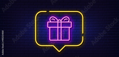Neon light speech bubble. Gift box line icon. Present or Sale sign. Birthday Shopping symbol. Package in Gift Wrap. Neon light background. Gift box glow line. Brick wall banner. Vector
