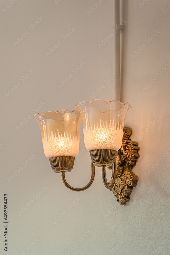 Beautiful retro brass wall lamp decoration for home and living and wall background with copy space.