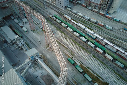 Aerial view of cargo train cars loaded with construction goods at mining factory. Railway transportation of industrial production raw materials