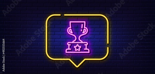 Neon light speech bubble. Winner cup line icon. Award trophy sign. Best achievement symbol. Neon light background. Winner cup glow line. Brick wall banner. Vector