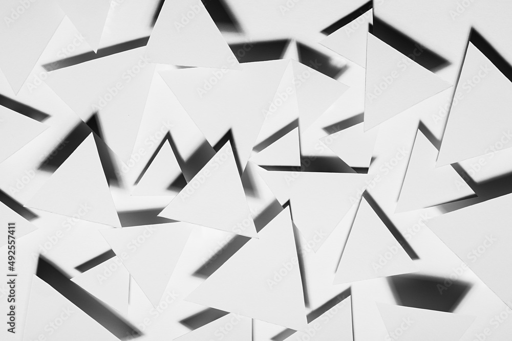White triangles geometric pattern in hard light with strict black shadows in random with sharp angles, top view. Energy and aggressive modern abstract background in minimal style. White triangles geometric pattern in hard light with strict black shadows in random with sharp angles, top view. Energy and aggressive modern abstract background in minimal style.