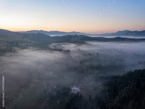 Morning mist in Ukrainian Carpathian mountains. Aerial drone view.