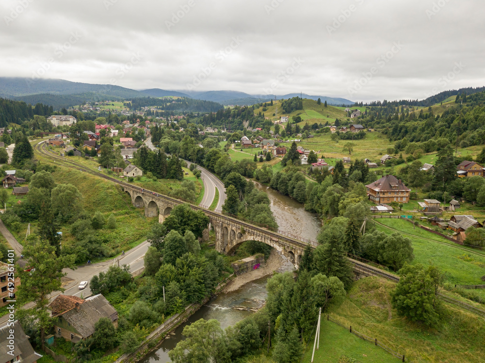 Old railway bridge in the mountains. Ukrainian Carpathians. Aerial drone view. Old railway bridge in the mountains. Ukrainian Carpathians. Aerial drone view.