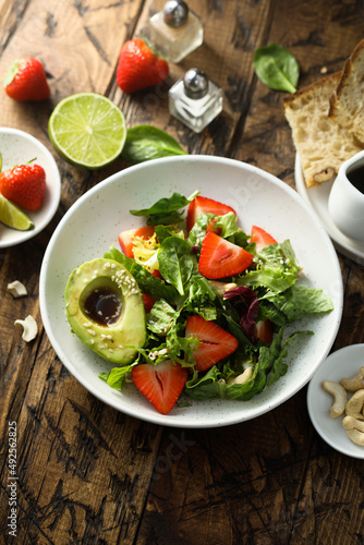 Healthy leaf salad with strawberry and avocado