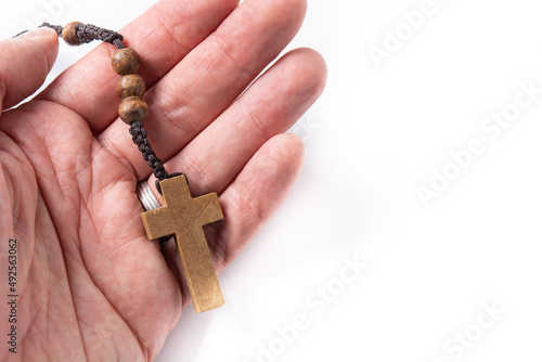 Hand with rosary catholic cross isolated on white background. Copy space