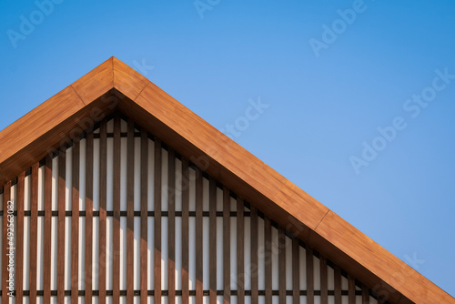 Photos Wooden gable roof with battens decoration of vintage house against blue clear sk