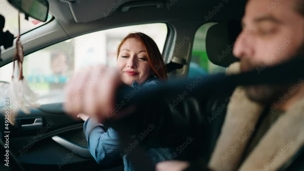 Man and woman couple smiling confident fastening seat belt at street Man and woman couple smiling confident fastening seat belt at street