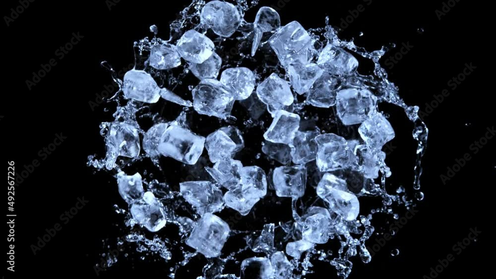 Super slow motion of rotating ice cubes with splashing water, top view shot. Filmed on high speed cinema camera, 1000 fps. Isolated on black background. Super slow motion of rotating ice cubes with splashing water, top view shot. Filmed on high speed cinema camera, 1000 fps. Isolated on black background.