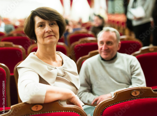 mature man and woman in theater watching a performance