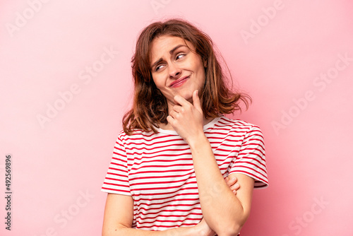 Young caucasian woman isolated on pink background suffers pain in throat due a virus or infection.