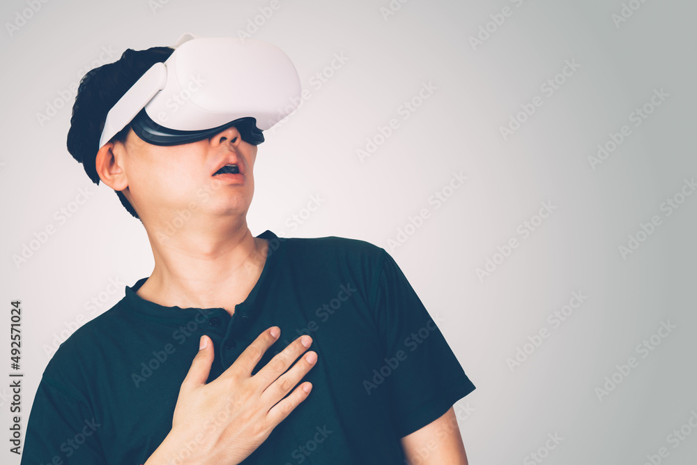 Portrait of young asian man wearing goggles virtual reality with excited isolated on white background, metaverse technology and device, innovation for entertainment and education with modern.