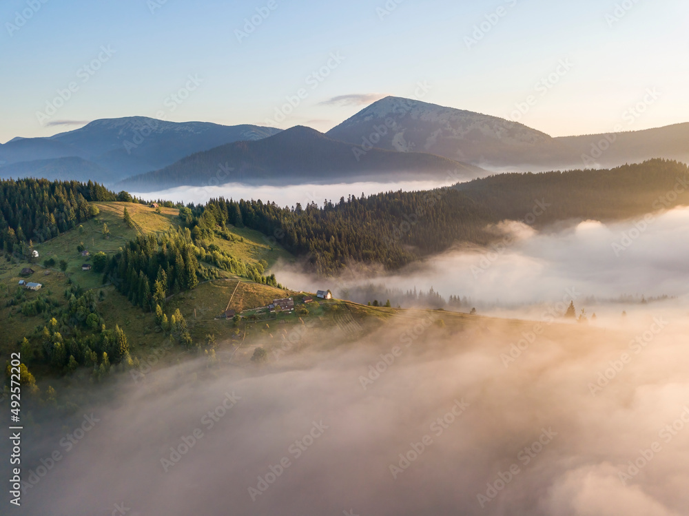 Sunrise over the fog in the Ukrainian Carpathians. Aerial drone view. Sunrise over the fog in the Ukrainian Carpathians. Aerial drone view.