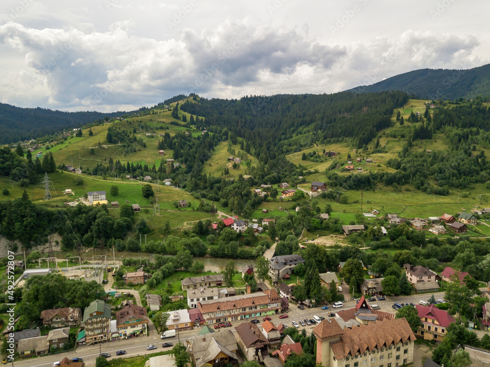 Settlement in the mountains of the Ukrainian Carpathians. Aerial drone view.