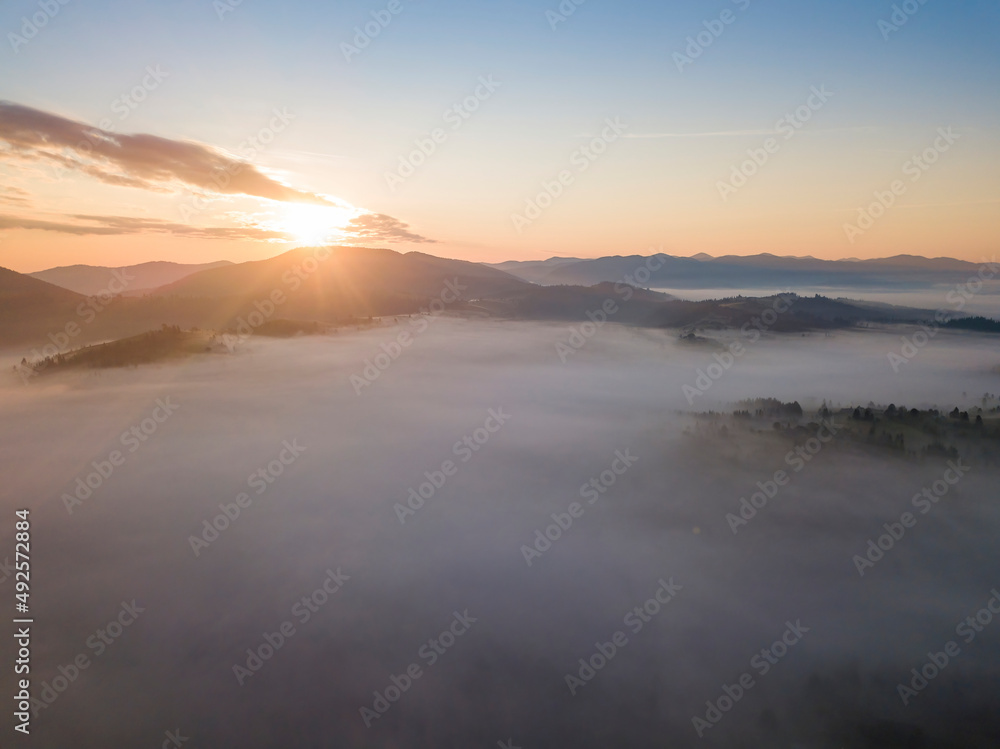 Sunrise over the fog in the Ukrainian Carpathians. Aerial drone view. Sunrise over the fog in the Ukrainian Carpathians. Aerial drone view.