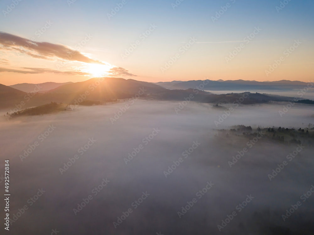 Sunrise over the fog in the Ukrainian Carpathians. Aerial drone view.