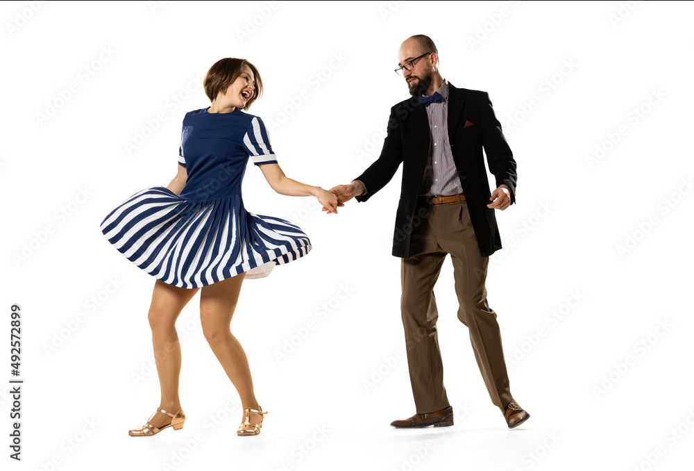 Social dancing. Couple of dancers, young man and woman in vintage retro style outfits dancing