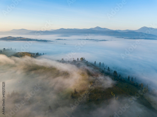 Morning mist in Ukrainian Carpathian mountains. Aerial drone view.