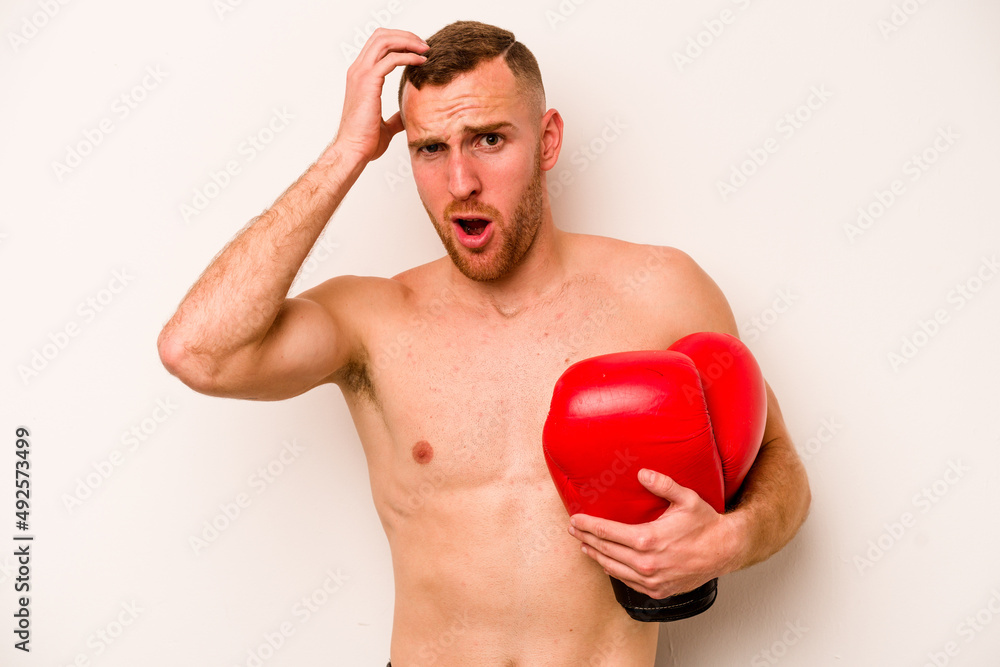 Young caucasian man doing boxing isolated on white background being shocked, she has remembered important meeting. Young caucasian man doing boxing isolated on white background being shocked, she has remembered important meeting.