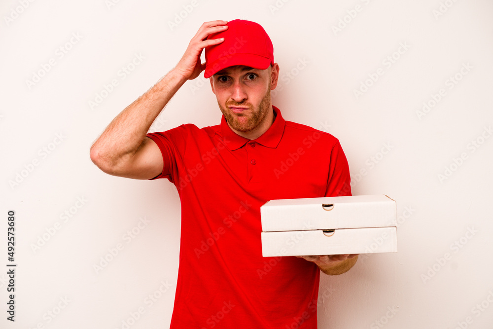 Young delivery caucasian man holding pizzas isolated on white background being shocked, she has remembered important meeting. Young delivery caucasian man holding pizzas isolated on white background being shocked, she has remembered important meeting.