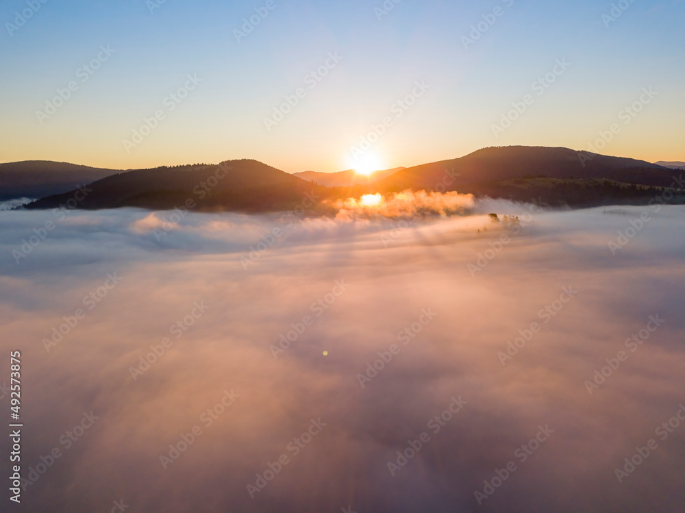 Obraz premium Sunrise over the fog in the Ukrainian Carpathians. Aerial drone view.