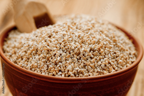 Barley groats in bowls and bags on a wooden background. High quality photo photo