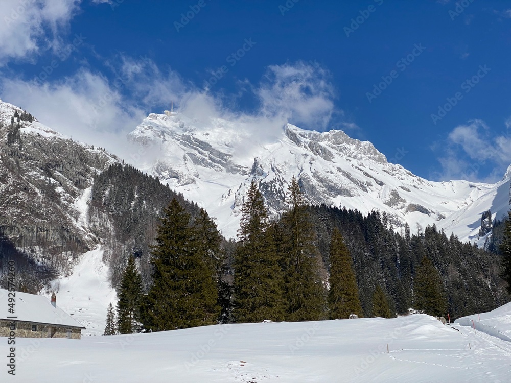 Fototapeta premium Snow-capped alpine peak Säntis (Saentis or Santis, 2502 m) in Alpstein mountain range and in Appenzell Alps massif, Unterwasser - Canton of St. Gallen, Switzerland (Schweiz)